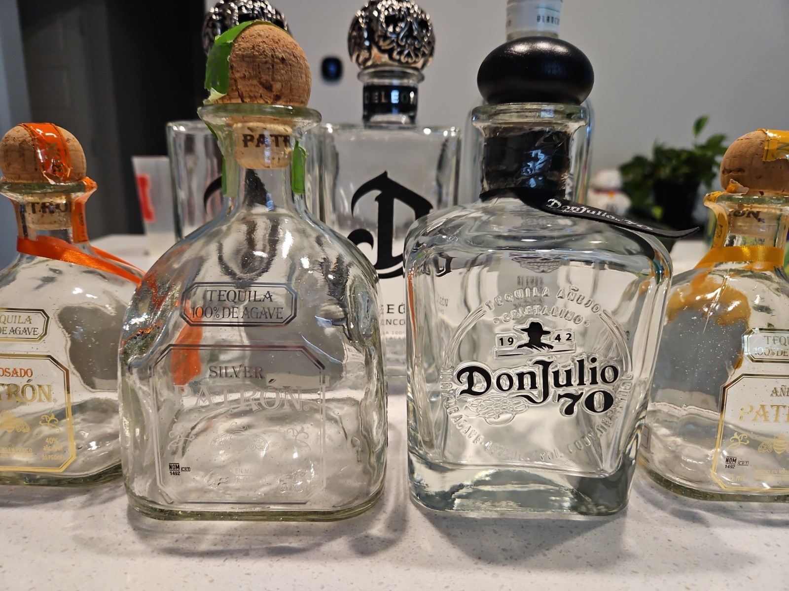 7 Tequila Bottle Lot: Deleon, Exotico, Don Julio, Patron W Toppers