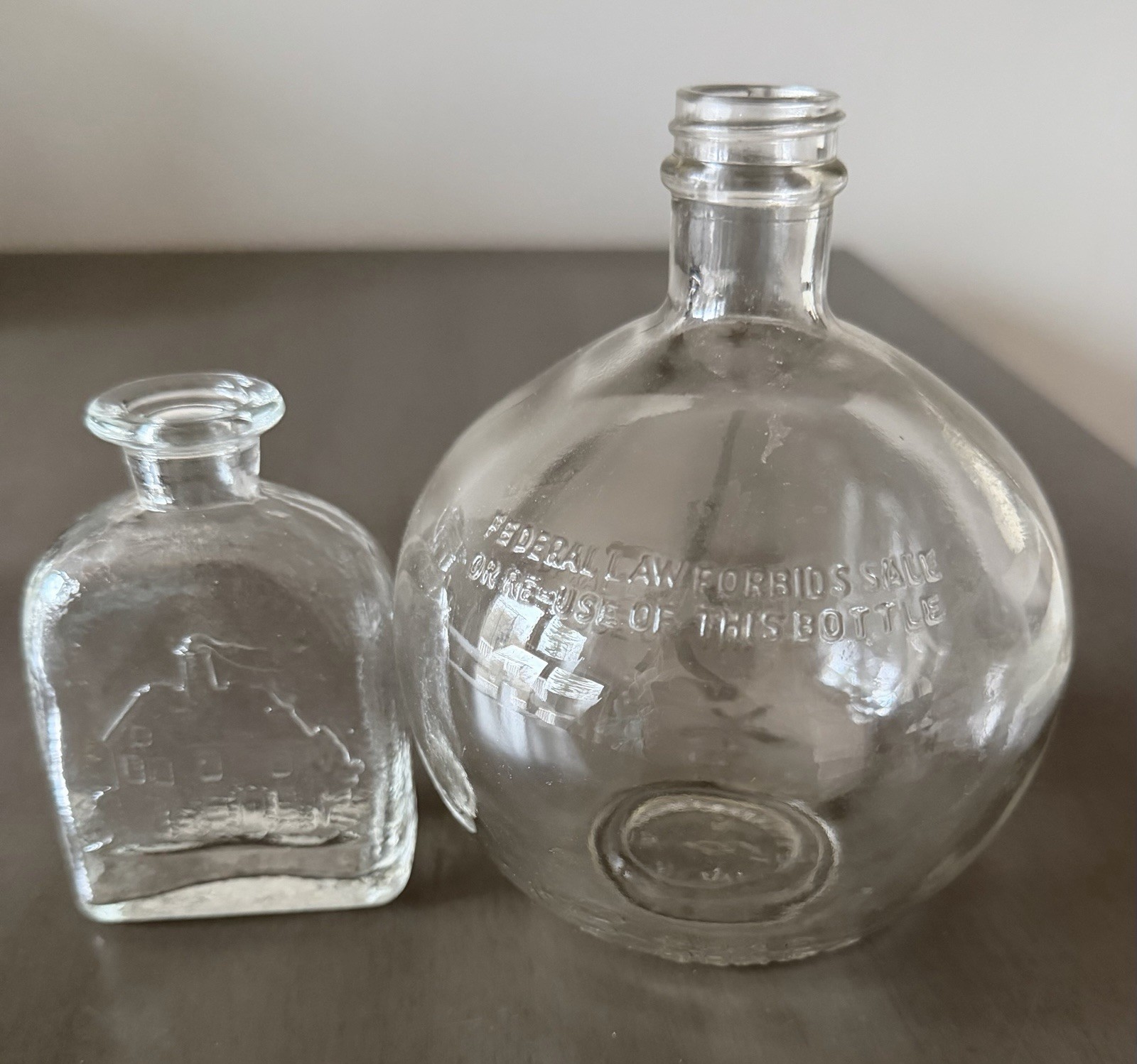 Vintage Ball Liquor Bottle And Vintage Cottage With Smoke In Chimney