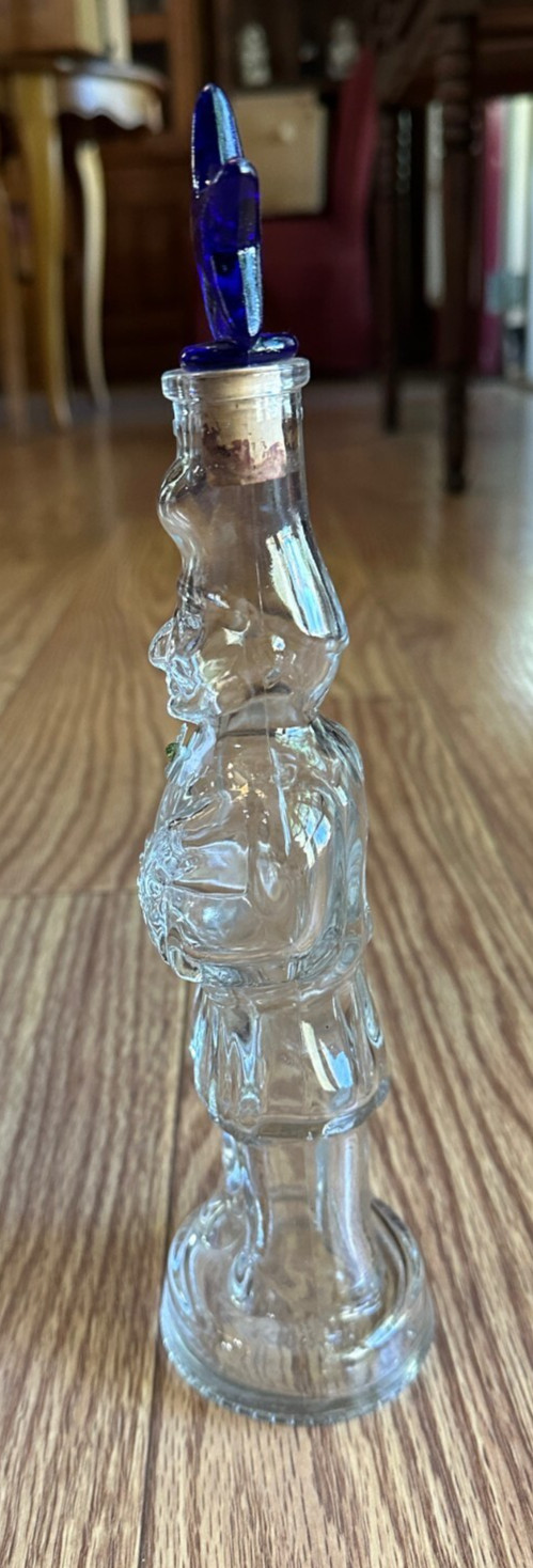 CLEAR GLASS BOTTLE OF MAN PLAYING UKULELE 11″ TALL WITH BLUE GLASS STAR STOPPER